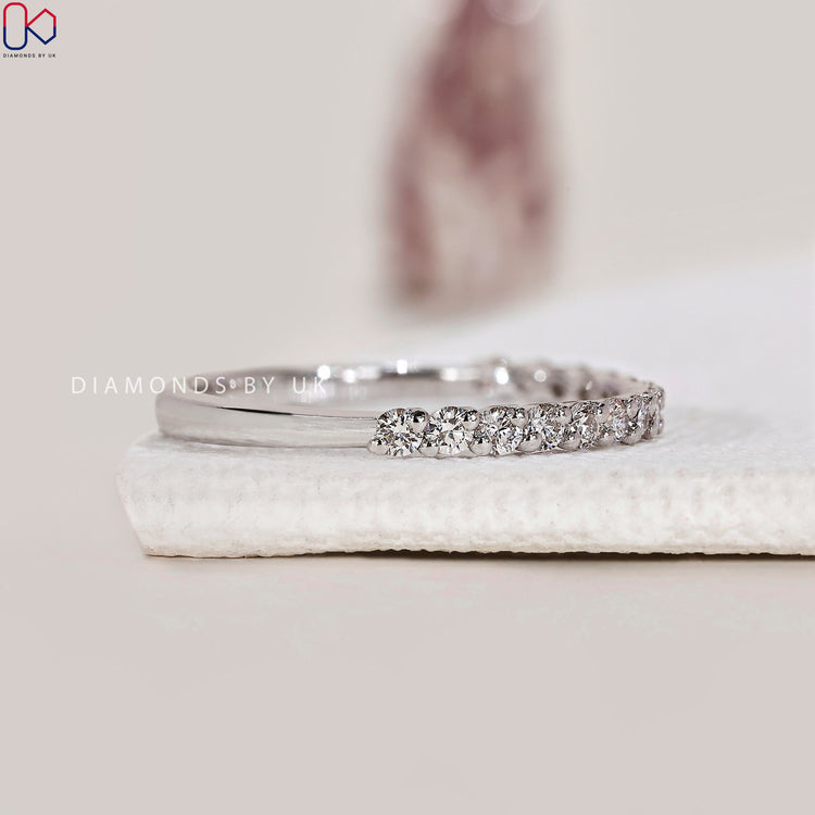 Prong diamond band offering brilliance and durability.
