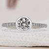 Bezel round diamond ring in white gold.
