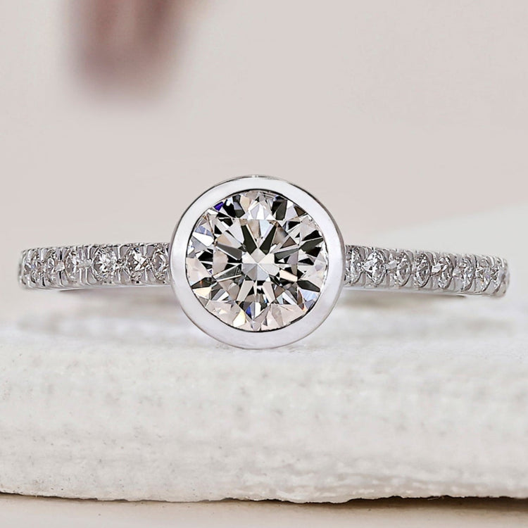Bezel round diamond ring in white gold.
