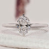 Oval solitaire engagement ring with white gold band.
