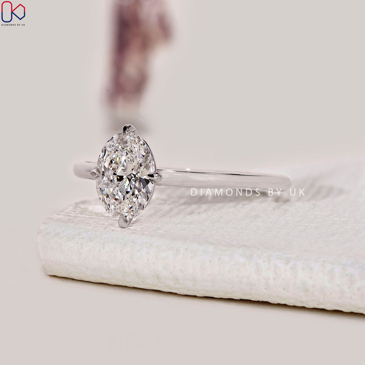 Solitaire engagement ring featuring oval diamond.
