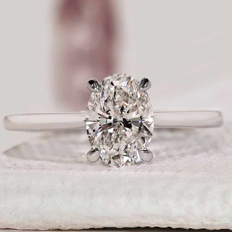 Oval solitaire engagement ring with cathedral setting ring.
