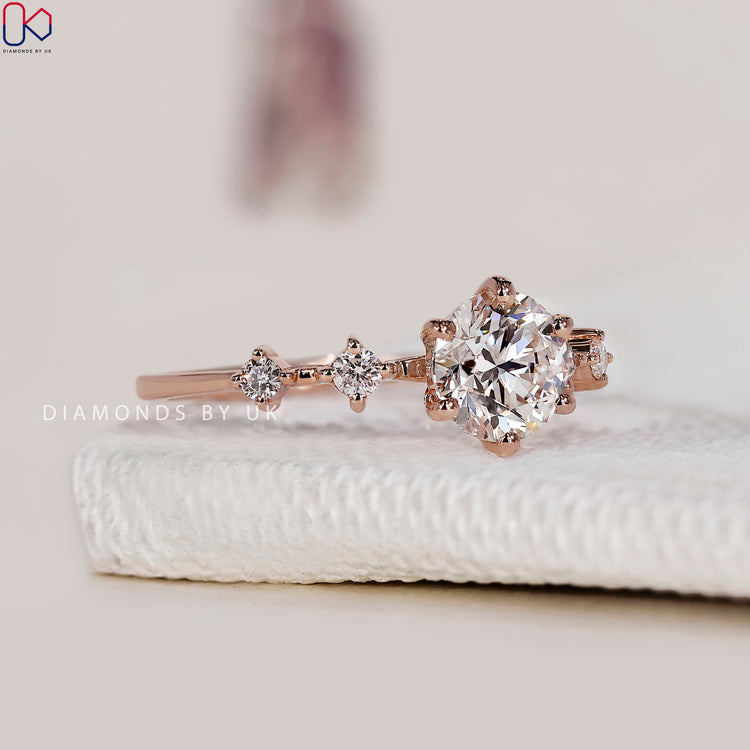 Rose gold engagement ring featuring five brilliant diamonds.
