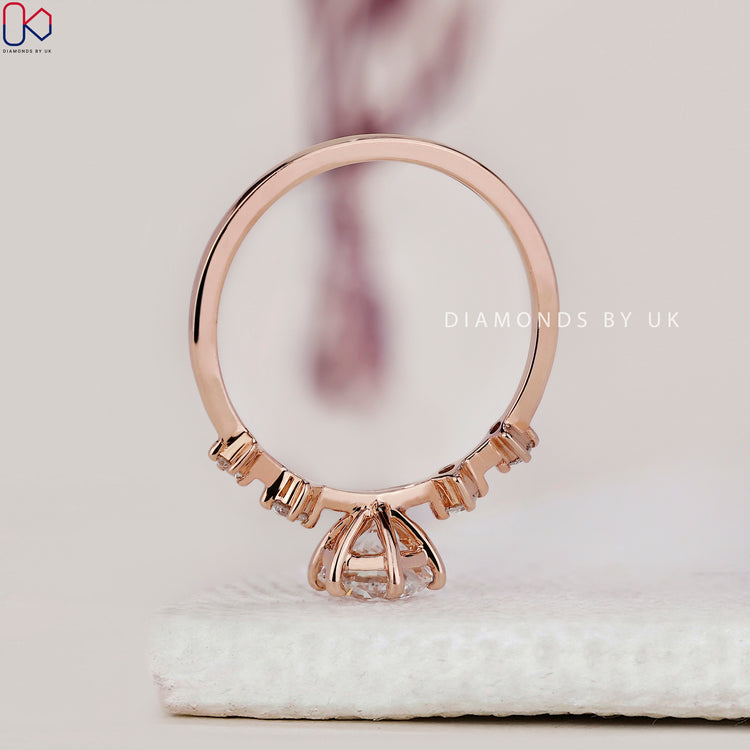 Rose gold diamond ring with five stones in a timeless design.

