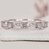 Round diamond wedding band paired with a chain link band.
