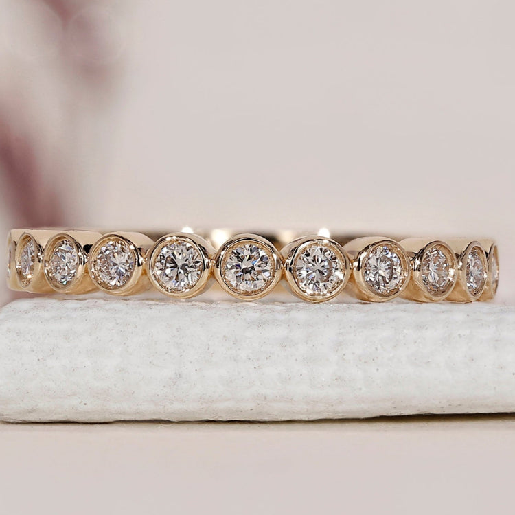 Yellow gold wedding band with a round diamond band for a classic look.
