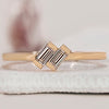 2 Diamond Engagement Ring featuring Baguette Diamonds, set in a minimalist yellow gold band.