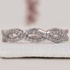 Twisted wedding band in white gold with elegant detailing.
