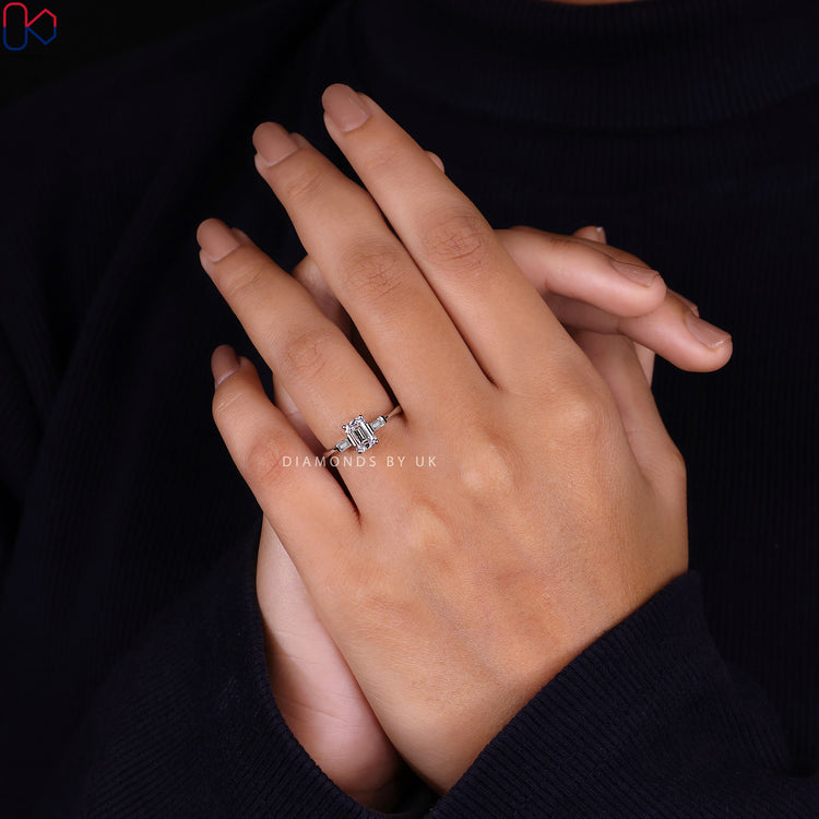 IGI certified emerald cut ring with a timeless 3 stone diamond design.
