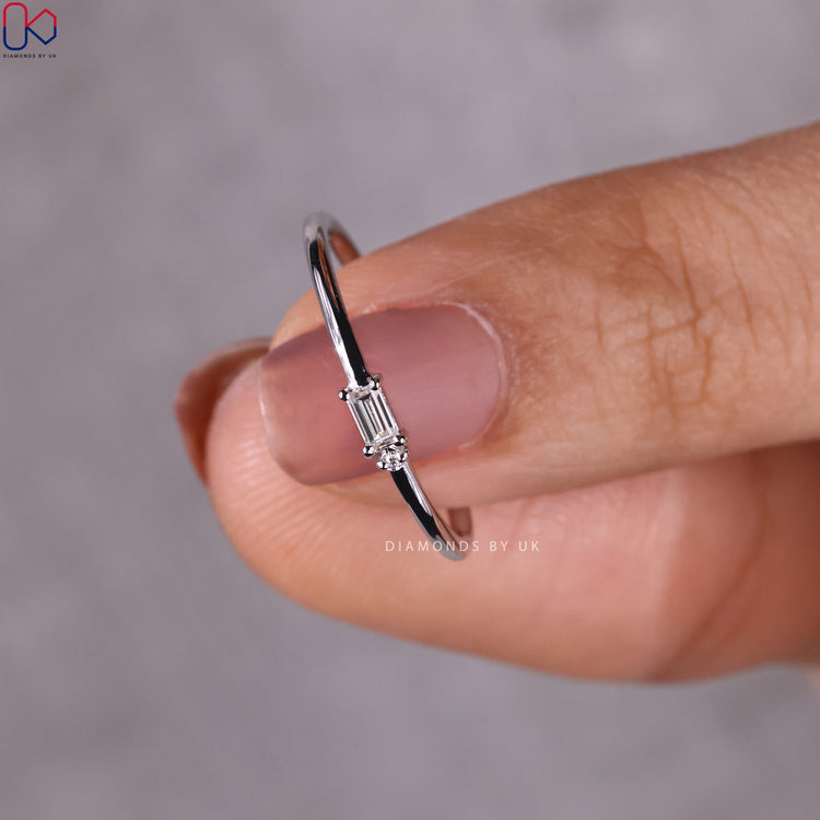 Womens white gold wedding band featuring round and baguette diamonds.
