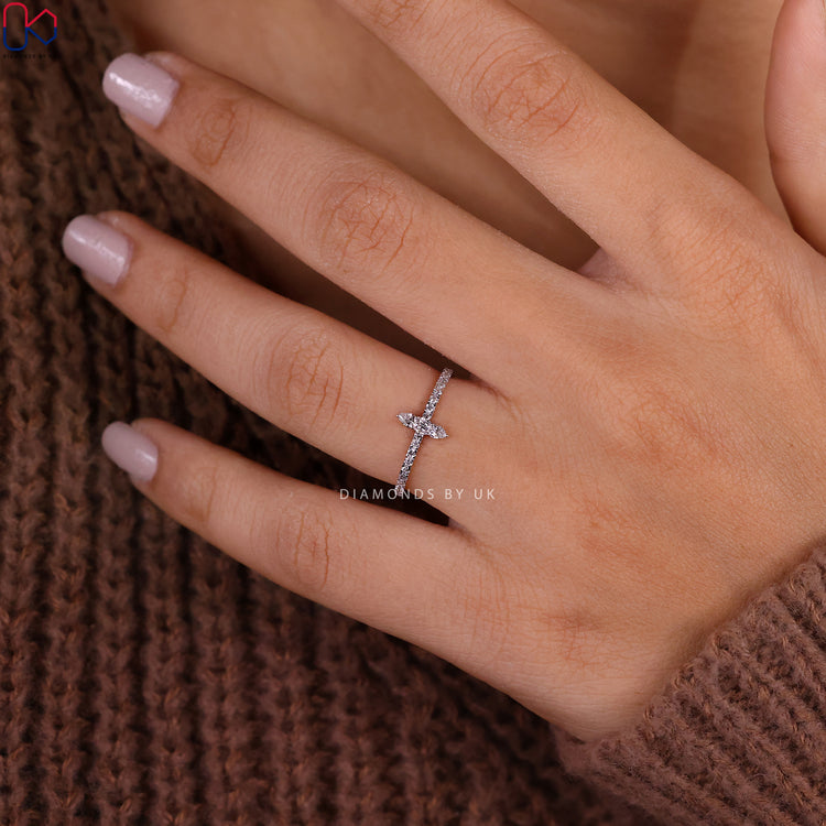 White gold band featuring a diamond half eternity design.

