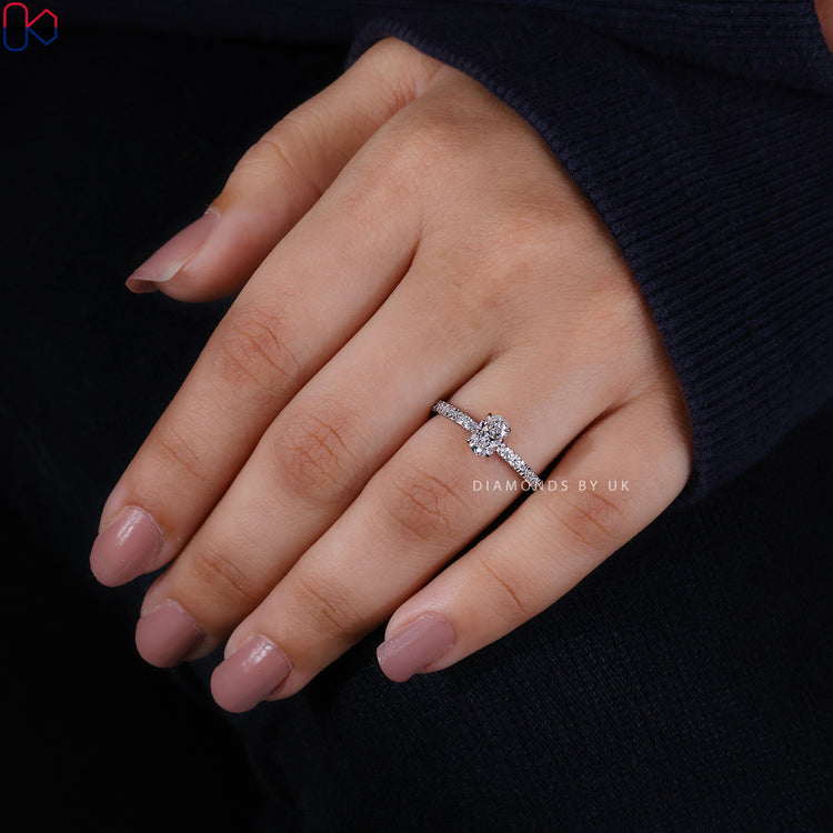 Oval cut diamond ring with delicate hidden halo.