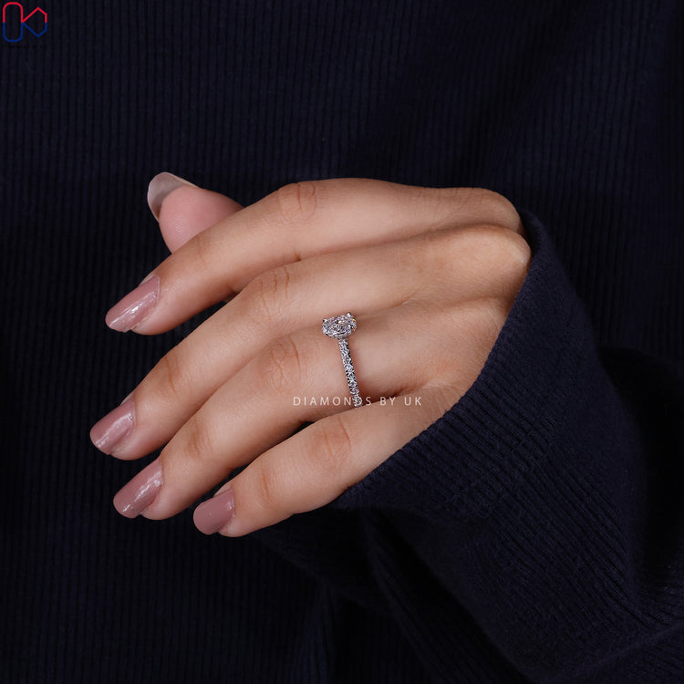 Handmade jewelry featuring oval diamond with pave band.