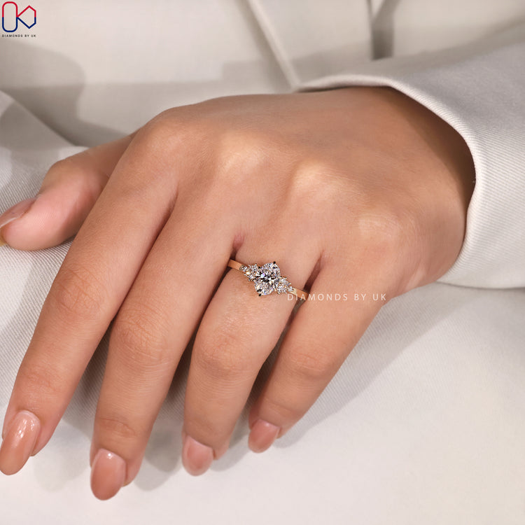 Lab grown diamond ring with oval center and yellow gold band.
