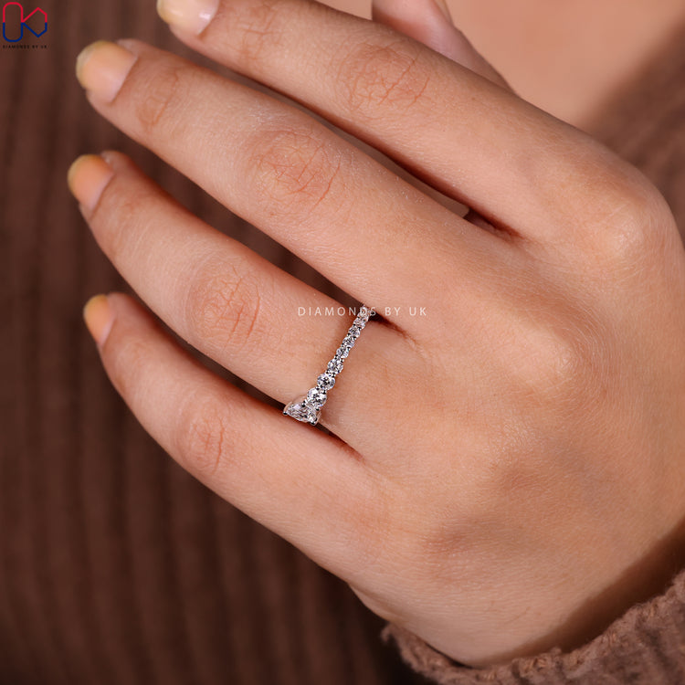 Half eternity wedding band with elegant stone arrangement.
