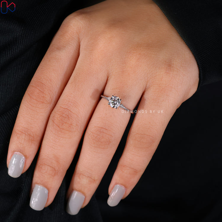 Milgrain ring design with intricate detailing and sparkling diamonds.
