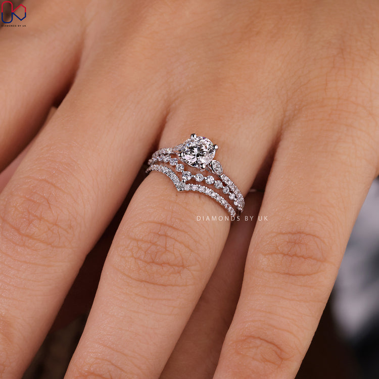 Curved wedding band with pave engagement ring and shared prong setting.
