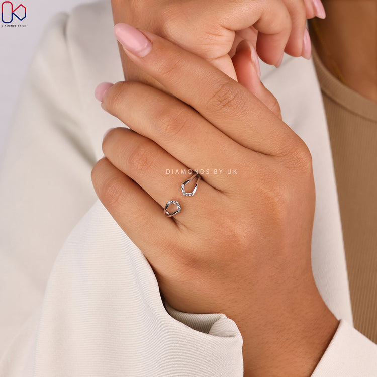 Diamondsbyuk engagement ring with geometric cuff design.
