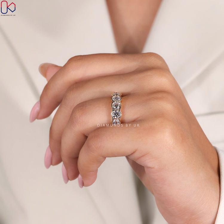Yellow gold wedding band for women featuring a polished and luxurious finish.
