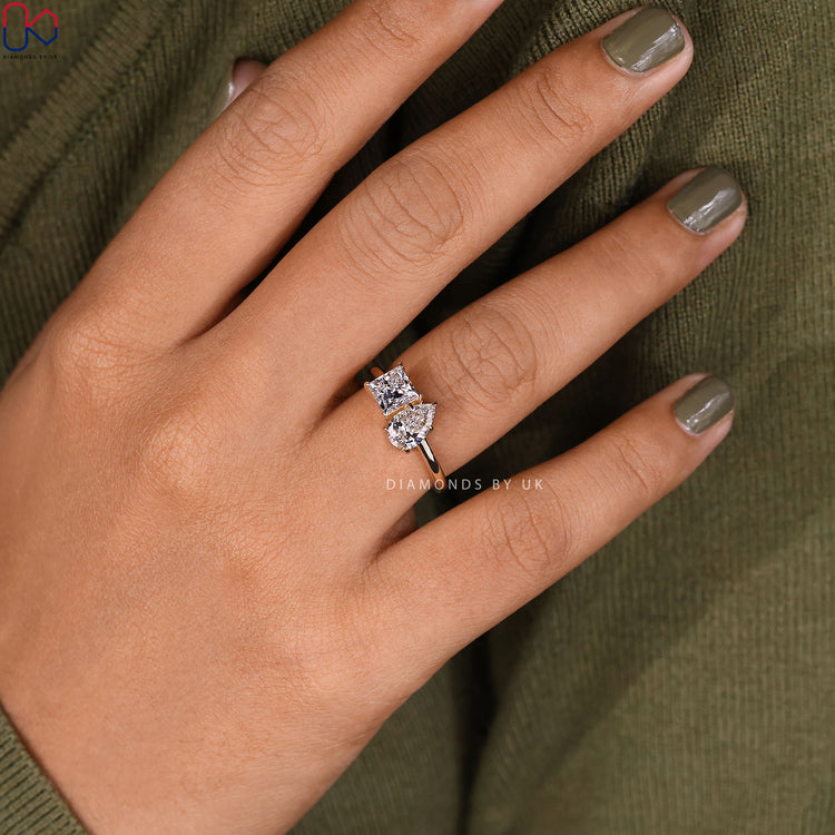 Pear and princess cut ring with detailed craftsmanship.
