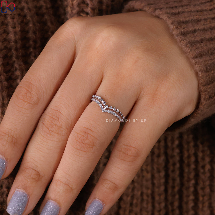 Handmade jewellery showcasing prong set wedding band and custom detail.
