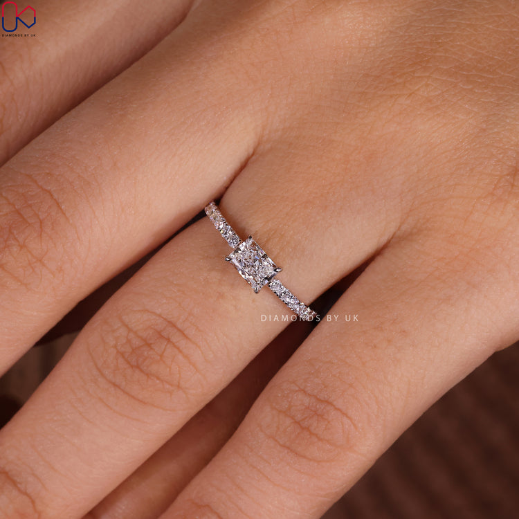 Claw prong ring featuring a radiant cut diamond in white gold.

