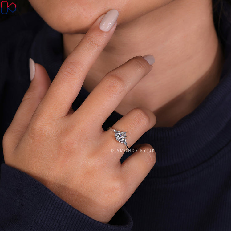 Prong setting ring with a tear drop diamond and baguette side stones.