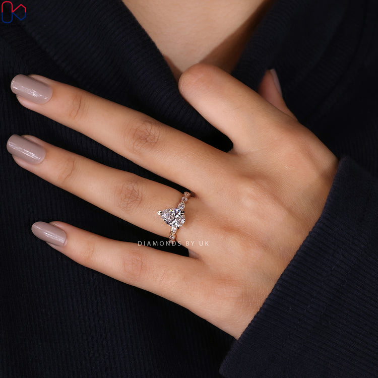 Yellow gold ring with pear shape and milgrain detail.

