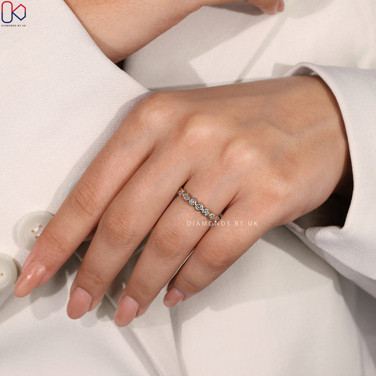 Round diamond ring set in a luxurious diamond eternity band.
