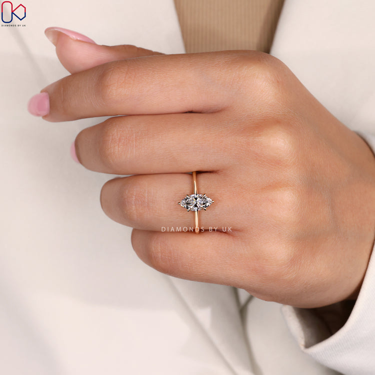 Round cut diamond ring with a hidden halo and gold band.
