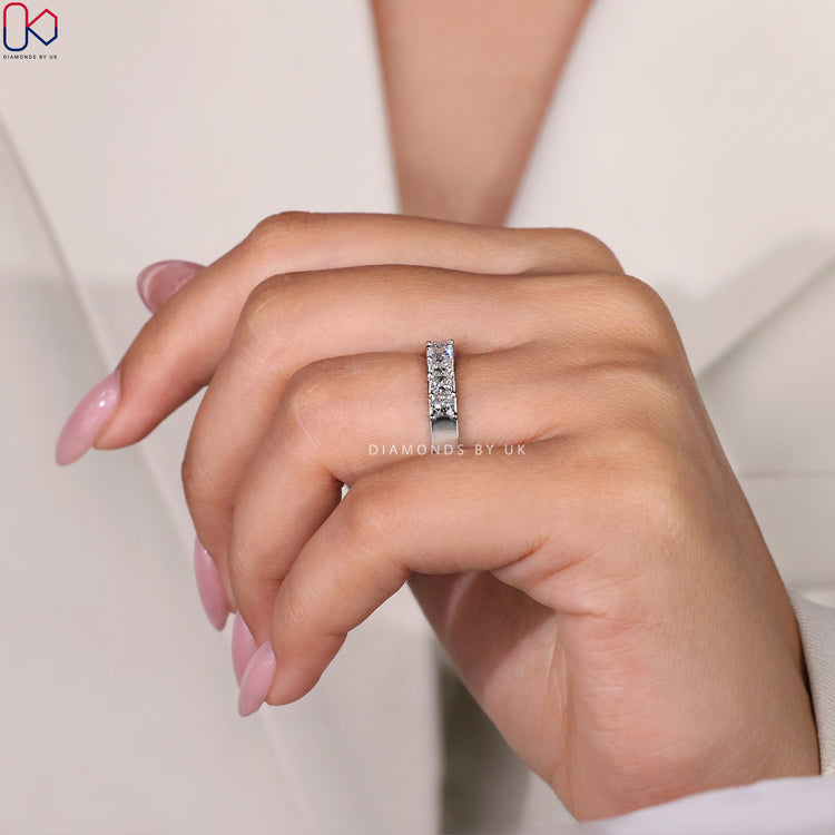 Shared prong band with sparkling princess cut diamonds for brilliance.

