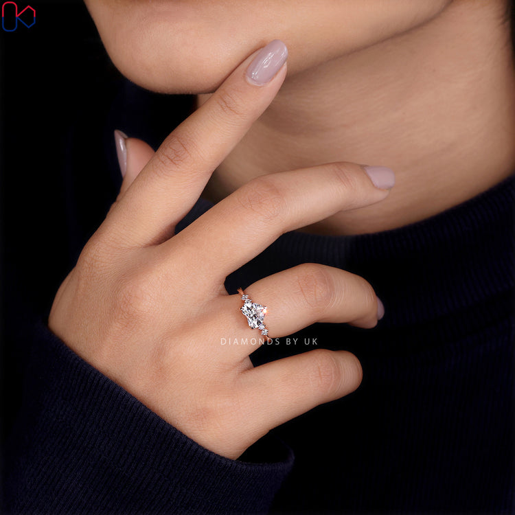 Round side stone engagement ring with a brilliant centerpiece
