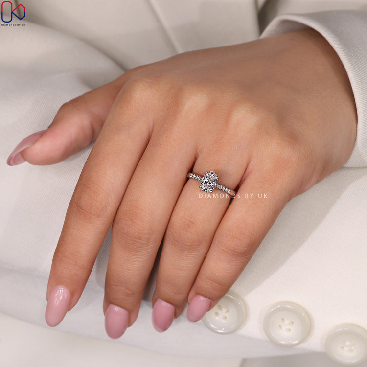 White gold ring featuring an oval cut ring with a hidden halo design.