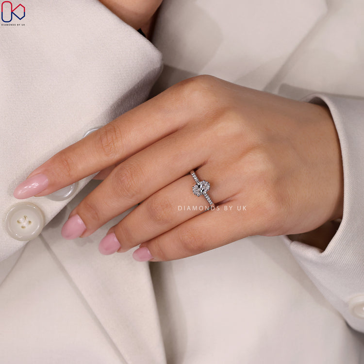 Diamondsbyuk engagement ring with an oval cut ring and a secure prong setting ring.