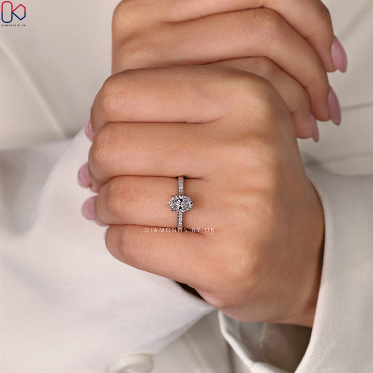 Hidden halo ring design paired with a brilliant oval cut ring.