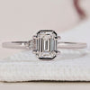 2 Stone Diamond Ring featuring round and emerald cut diamonds.