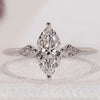 Marquise and Round Diamond Engagement Ring with a 3 diamond trilogy design.
