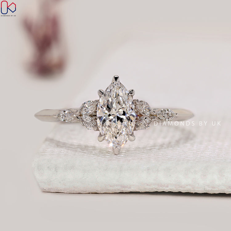 Marquise cut engagement ring with side stones.
