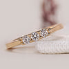 Round diamond wedding band with tapered shank design.

