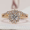 Round engagement ring and wedding band with halo setting.
