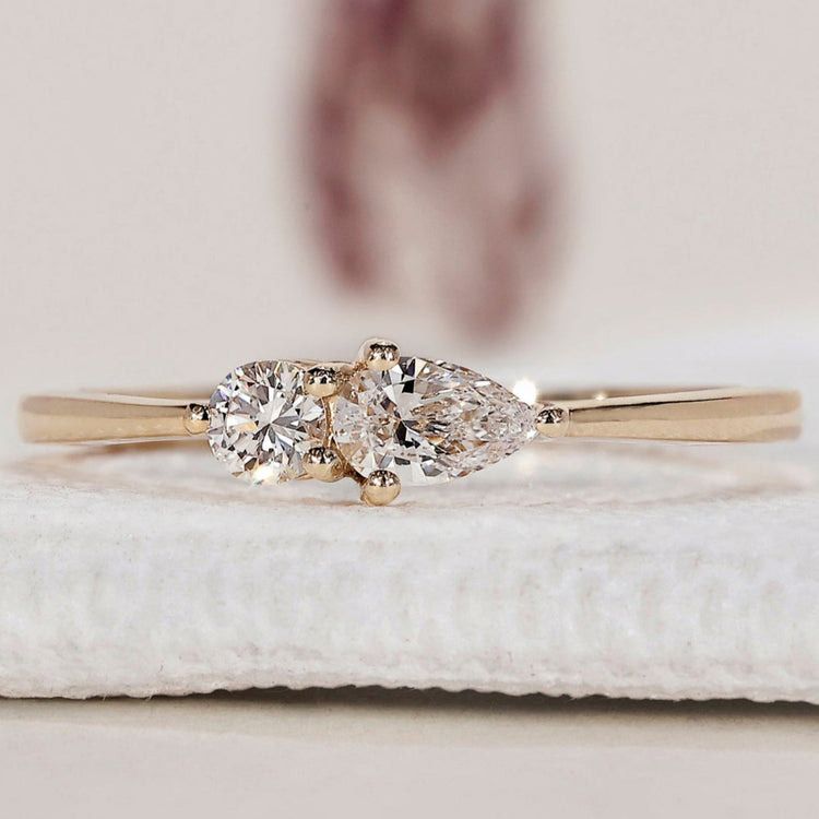 Two Stone Engagement Ring with round diamond and pear shape.
