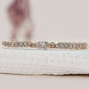 Minimalist wedding band in yellow gold with marquise cut stones.
