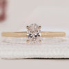 Solitaire engagement ring featuring an oval cut diamond.
