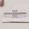 Cushion Diamond Ring with round side diamonds, hidden halo, and a pave band setting for an elegant touch.
