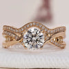 Round engagement ring with wedding band featuring a wave eternity band.
