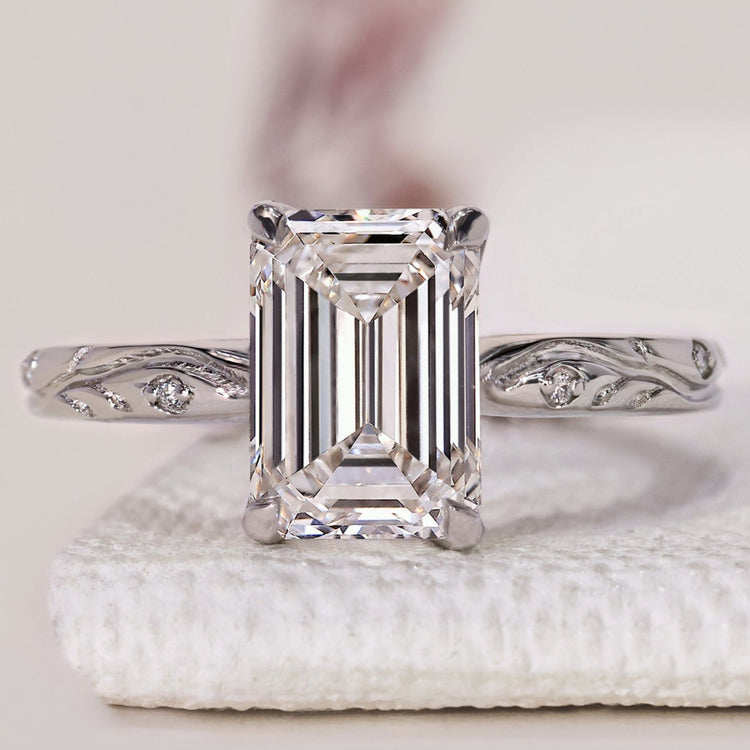 Emerald Diamond Ring featuring an Emerald Cut and side diamonds for an elegant engagement look.
