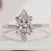 Marquise Diamond Engagement Ring with round side diamonds, set in white gold with a tapered shank band for a unique design.
