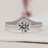 Round cut engagement ring with wedding band featuring 6 claw prong setting.
