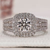 Double halo engagement ring featuring a round cut diamond set in white gold.