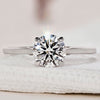 Hidden halo engagement ring with round diamond and white gold.
